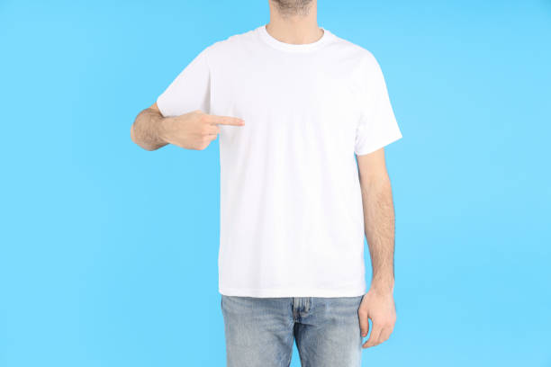 istock Man in blank white t-shirt on blue background 2129826990
