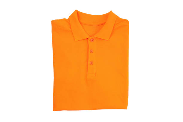 istock Blank folded orange t-shirt isolated on white background 2129827650