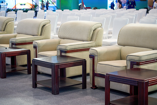 Close-up of VIP sofa seats in the first row of a large business conference