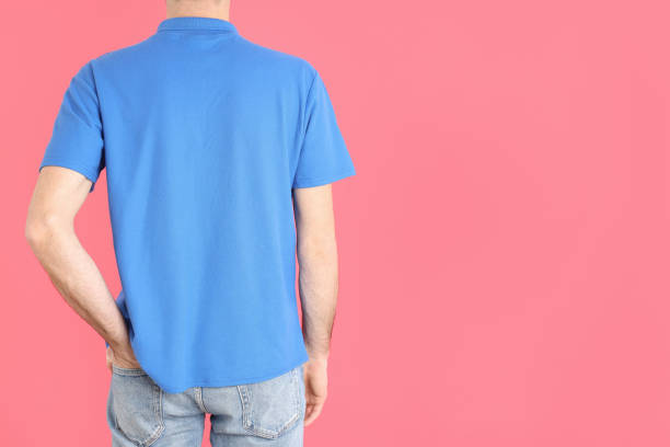 istock Man in blank blue polo on pink background 2129831026