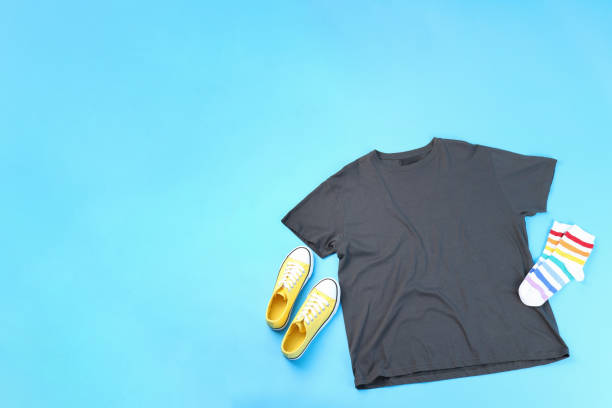 istock Blank t-shirt, sneakers and socks on blue background 2129834285
