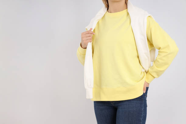 istock Woman in blank sweatshirt on light gray background 2129838579