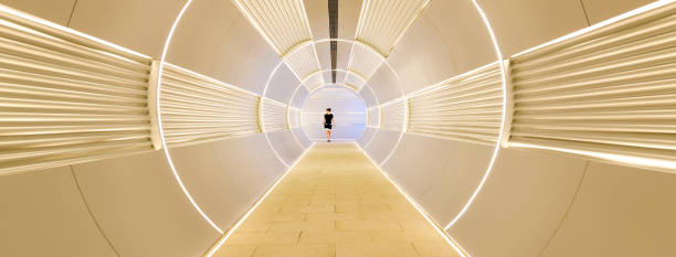 Woman walking in corridor tunnel
