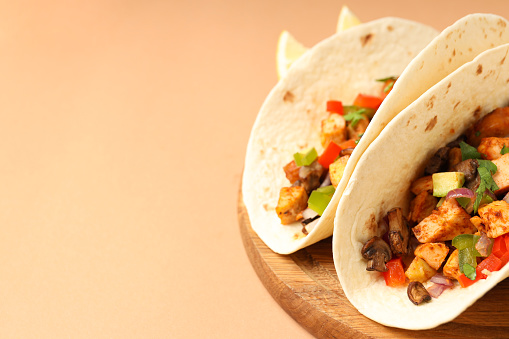 Concept of tasty food with taco on beige background
