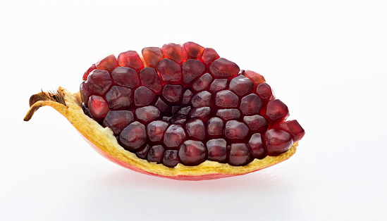 Piece of pomegranate on white background.