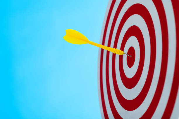 istock Dart arrow on center of dartboard 2129854546