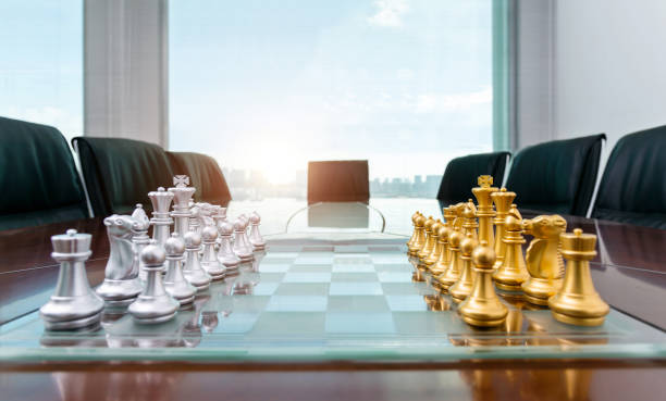 chess pieces and board on office table - chess strategy business board room стоковые фото и изображения