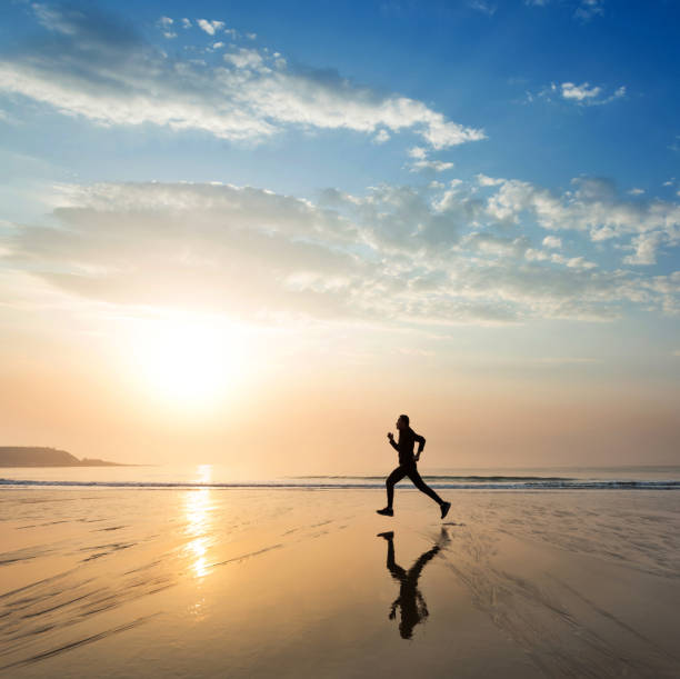 Man running on the golden beach