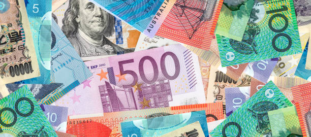 istock scattered collection of money from different countries 2129858845