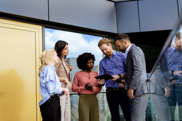 istock Business Professionals Engaging in a Strategy Discussion Outside a Modern Office Building 2129868949