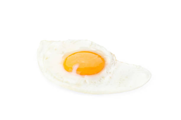 istock Fried eggs isolated on white background, close up 2129879163