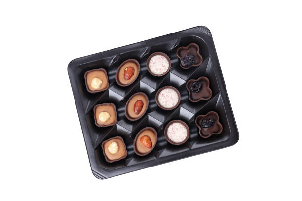 istock Chocolate candies in box isolated on white background 2129890757