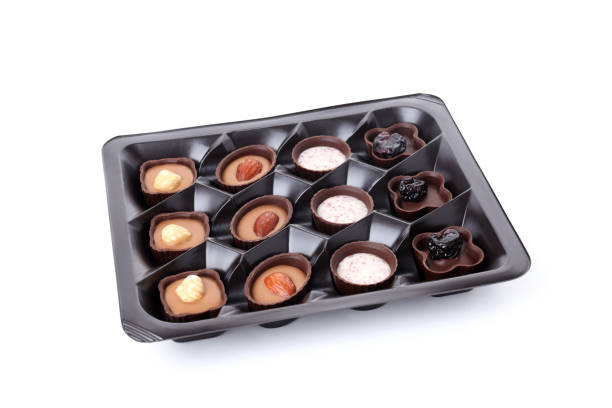 istock Chocolate candies in box isolated on white background 2129891076