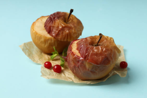 istock Stuffed baked apples on blue background, close up 2129900045