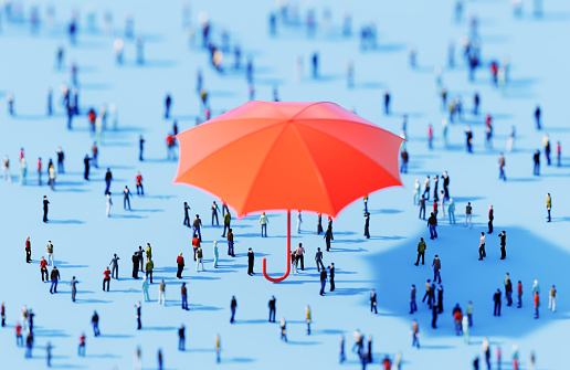 Human crowd surrounding an umbrella object on blue background. Horizontal  composition with copy space.
