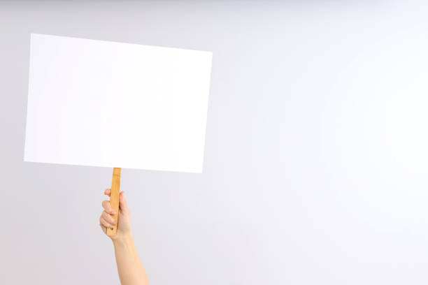 istock Hand holds protest sign on light background 2129919935