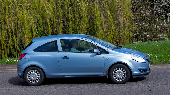 Milton Keynes,UK- Apr 1st 2024:  2008 blue Vauxhall Corsa car driving on a British road