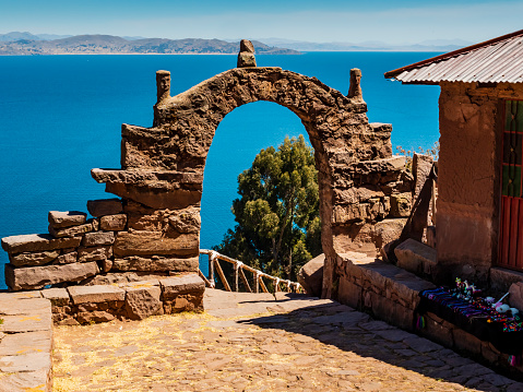 Amazing landscape on island Taquile with typical stone arch, Lake Titicaca, Puno region, Peru