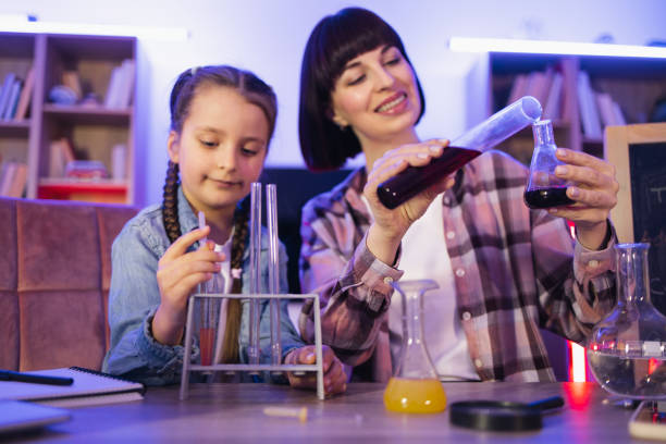 istock Caucasian mother making chemical experiments or tests with smart cute daughter. 2129975112