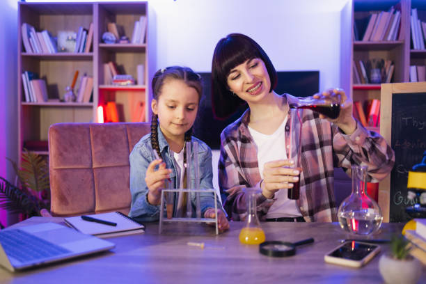 istock Young woman and small girl improving knowledge enjoying studying. 2129975157