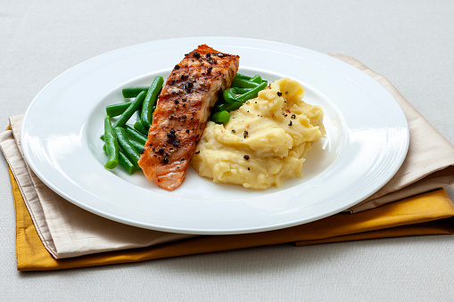 Grilled salmon on fresh vegetables and mashed potatoes