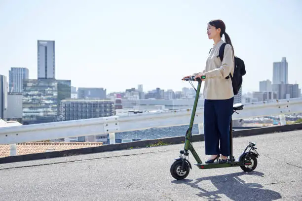 Japanese woman traveling on electric kickboard