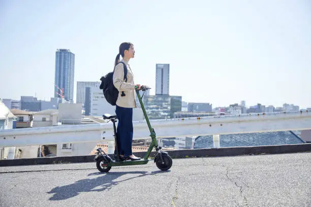 Japanese woman traveling on electric kickboard