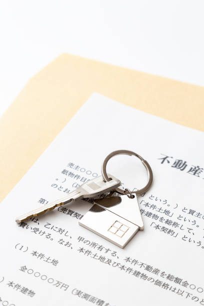 istock Real estate sales contract and keys on white background 2130105652