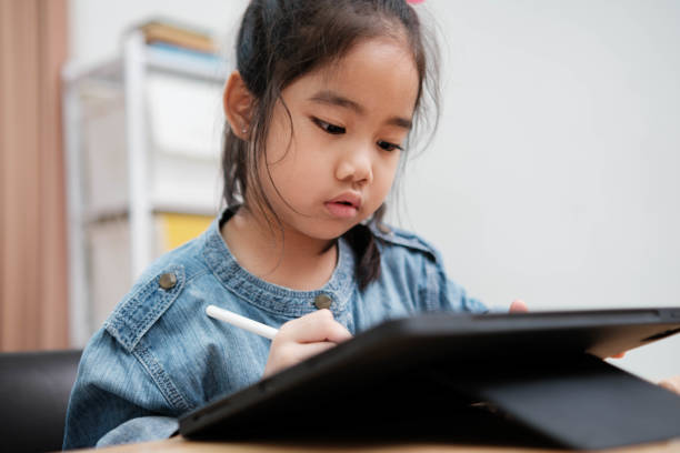 istock A young girl is playing with a remote control a robot 2130114658
