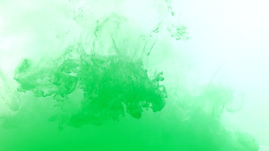 Green color dye melt in water on white background,Abstract smoke pattern,Colored liquid dye,Splash paint