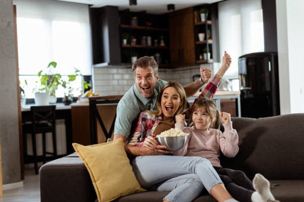 istock Family Movie Night: Engrossed in Thrilling Scenes at Home 2130142794