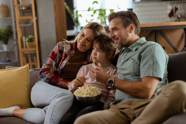 istock Family Movie Night: Engrossed in Thrilling Scenes at Home 2130142800