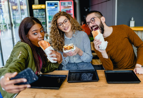 istock Friends taking selfies in fast food restaurant 2130154721