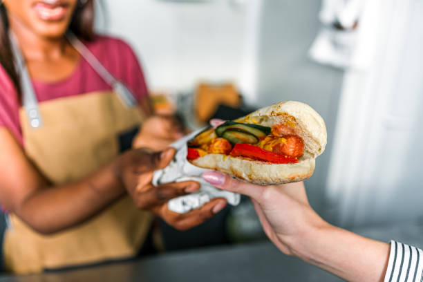 istock Female food vendor serving customer 2130155234