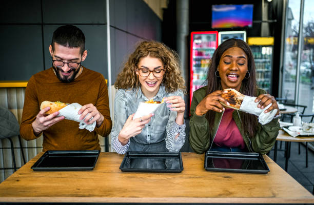 istock Friends eating in fast food restaurant 2130156770