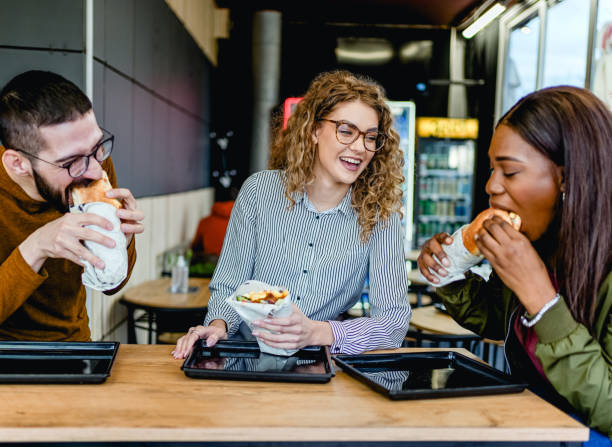 istock Friends enjoying lunch at a fast-restaurant 2130157279