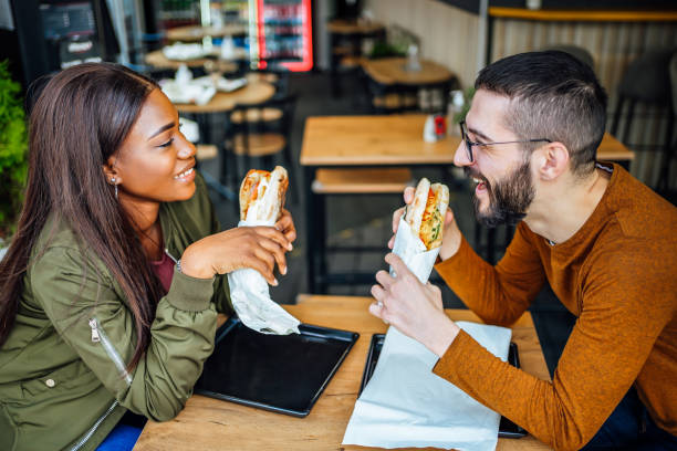 istock Friends eating in fast food restaurant 2130160418