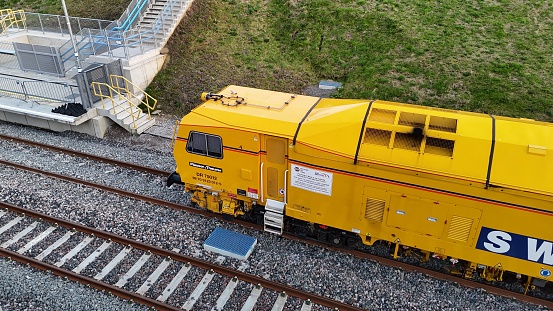 Winslow, United Kingdom – March 27, 2024: Aerial view of a yellow train at EWR Winslow Station