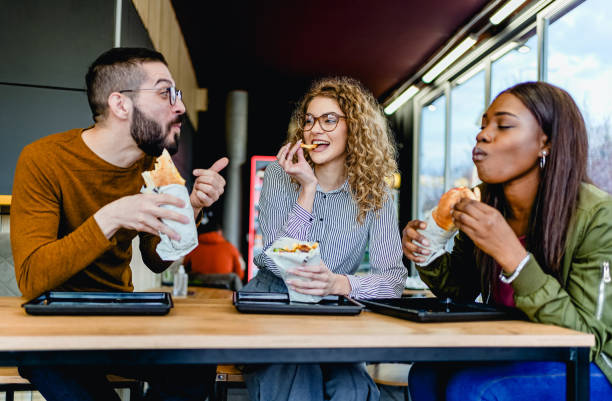 istock Friends enjoying lunch at a fast-restaurant 2130161803