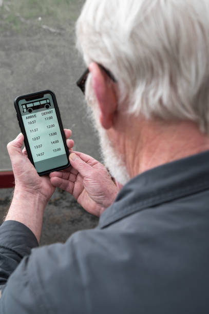 istock Senior man looking at a bus timetable 2130162035