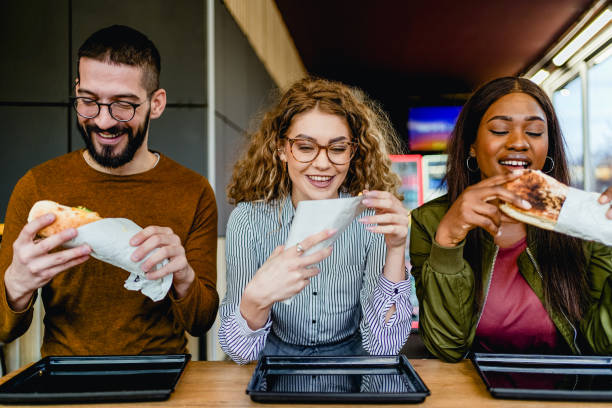 istock Friends eating in fast food restaurant 2130162044