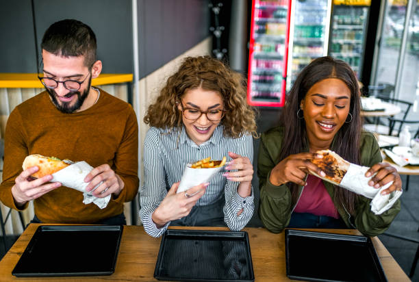 istock Friends eating in fast food restaurant 2130162637