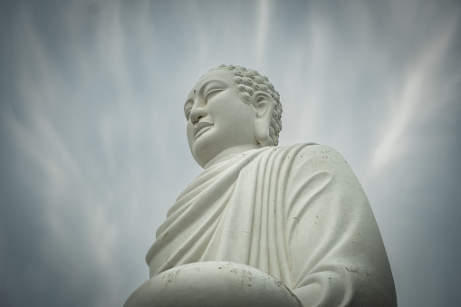Big Buddha statue at the Long Son pagoda in Nha Trang Vietnam. Buddha statue sits on a white lotus - Nha Trang, Black and white photo
