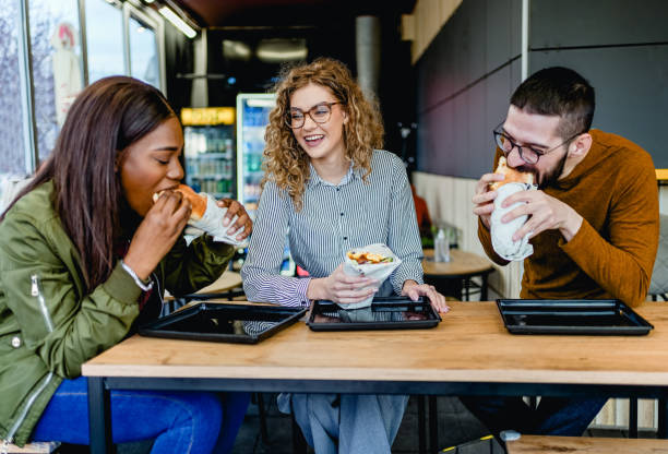 istock Friends enjoying lunch at a fast-restaurant 2130173819