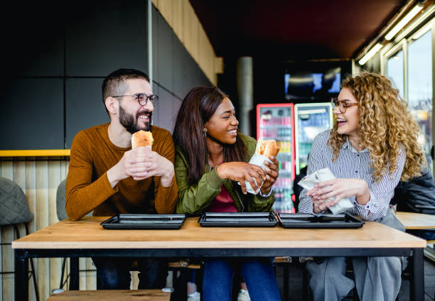 istock Friends eating in fast food restaurant 2130175903
