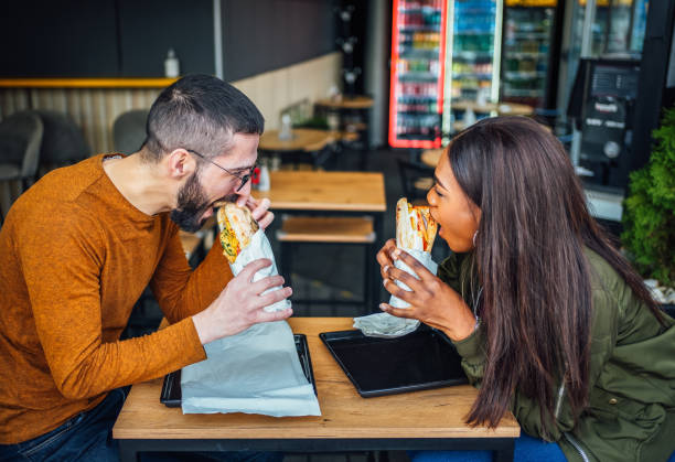 istock Couple eating in fast food restaurant 2130176419