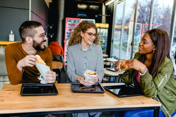 istock Friends enjoying lunch at a fast-restaurant 2130176929