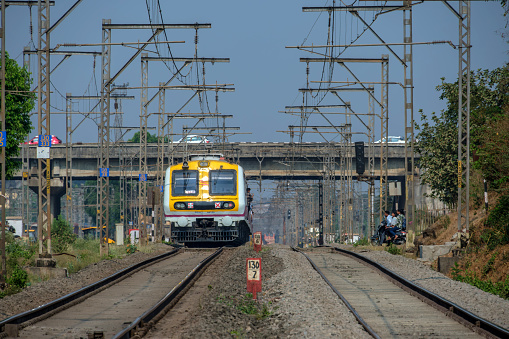 Pune, India - March 31 2024: A local suburban commuter train in the countryside  near Pune India.