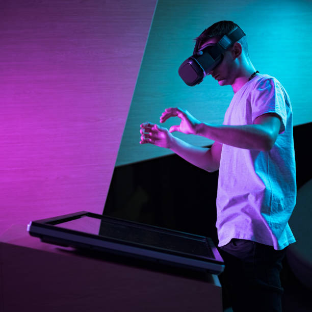 istock Man with a VR headset making various hand movements in the air 2130285028