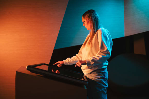 istock Adolescent girl using touch screen display on museum exhibition 2130286605